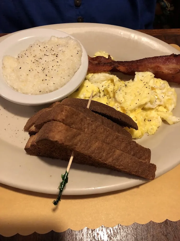 Scrambled Eggs with Bacon and a Bowl of Grits with a Side of Toast